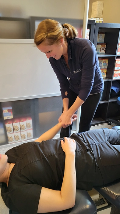 Chiropractor Western Springs IL Michelle McPolin Boyd Adjusting Patients Arm Chiropractor Western Springs IL Michelle McPolin Boyd Adjusting Patients Arm